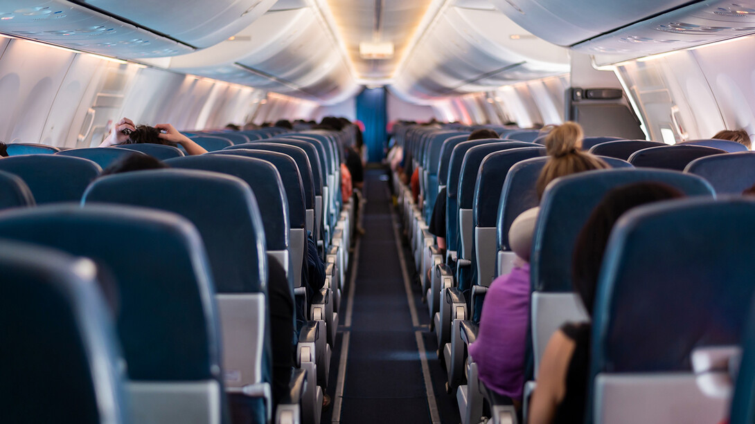 The backs of rows of seats in an airplane