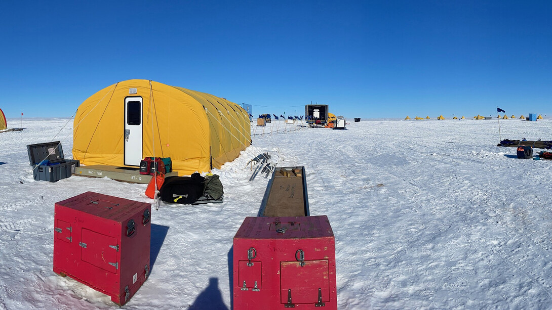 A yellow living unit at an Antarctic ice drill site.