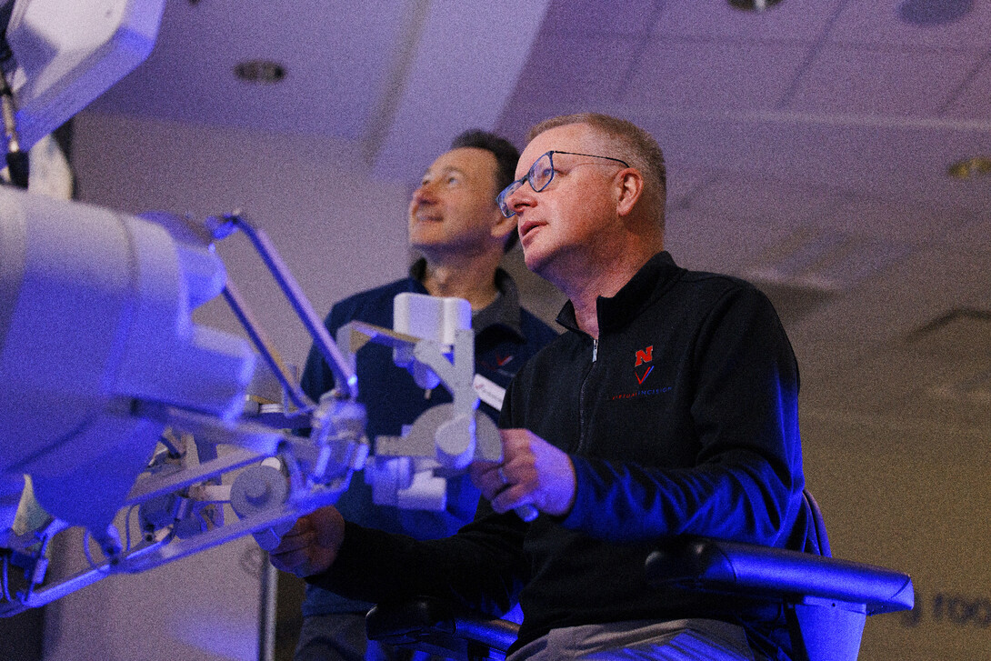 Nebraska Engineering professor and Virtual Incision co-founder Shane Farritor takes a turn using the surgical robot as Dr. Dmitry Oleynikov watches.