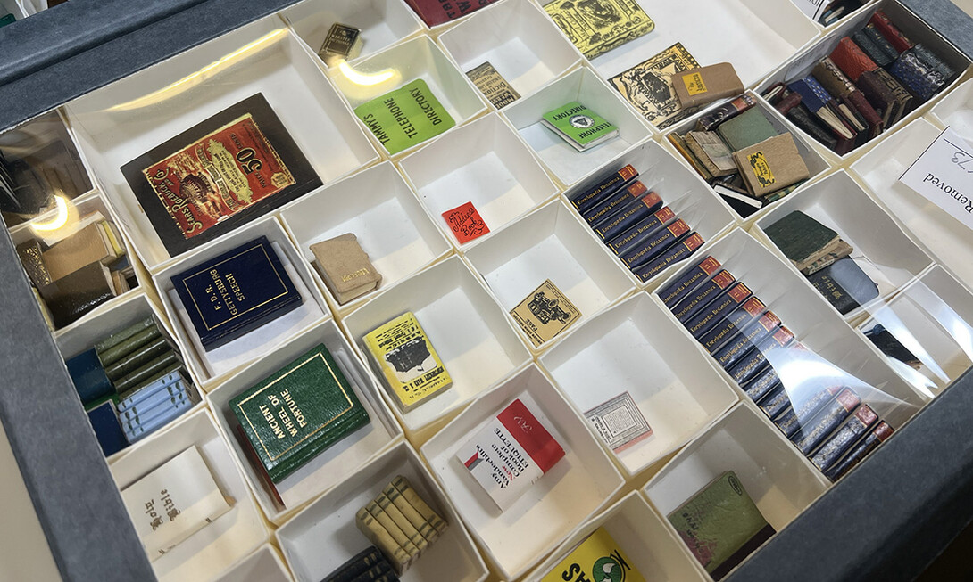 The gallery includes storage cabinets, and as the miniatures are catalogued, they are added to the gallery storage. Here, a drawer of books includes a set of Encyclopedia Britannica, telephone directories and others. 