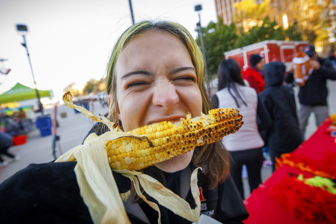 Lani Bohmont bites into an ear of grilled corn at the 2023 Cornstock Festival.