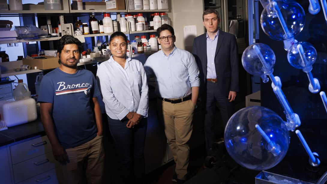 Husker researchers (from left) are Md. Ibrahim Kholil and Rashmeet Khurana, both graduate students in chemistry; Saman Bagheri, postdoctoral research associate in chemistry; and Alexander Sinitskii, professor of chemistry. The researchers stand in a lab.