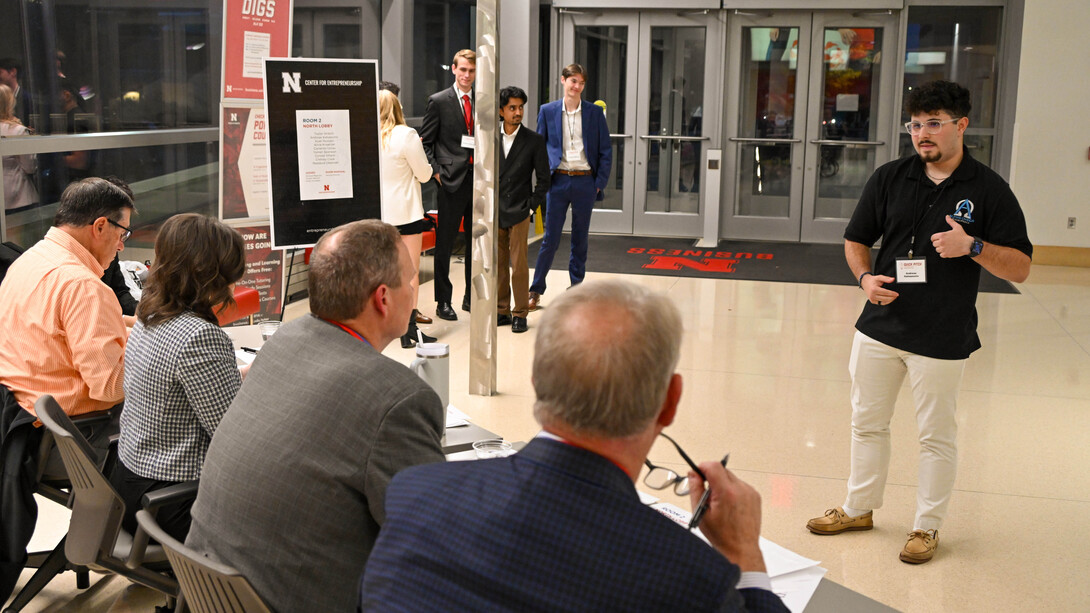 Andreas Katsaounis speaks to a panel of judges as fellow Quick Pitch competitors wait in the background.