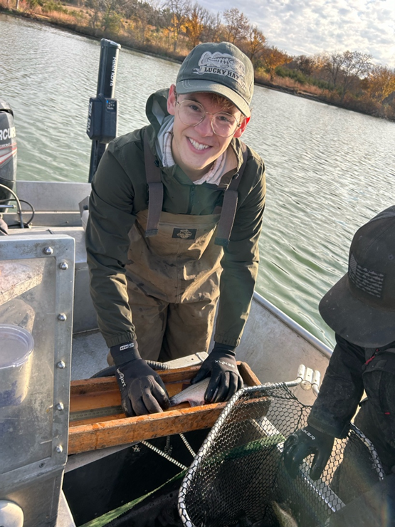 Jacob Vankat measures a white perch at Wildwood Lake, south of Valparaiso, Nebraska, as part of a class project on invasive carp.