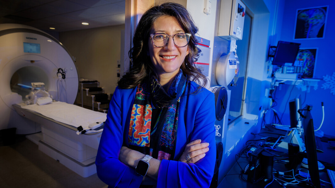 Maital Neta, professor of psychology, poses for a portrait inside the Center for Brain, Biology and Behavior's MRI room.