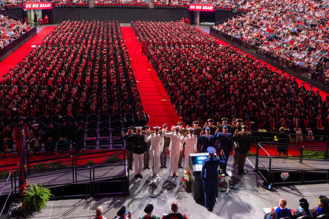 Air Force, Army and Naval ROTC members recite the oath of enlistment in front of hundreds of their fellow graduates during the afternoon undergraduate commencement ceremony May 17 at Pinnacle Bank Arena.