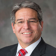Color portrait of Lance C. Pérez, Fred Hunzeker Dean of Engineering, wearing a suit and tie.