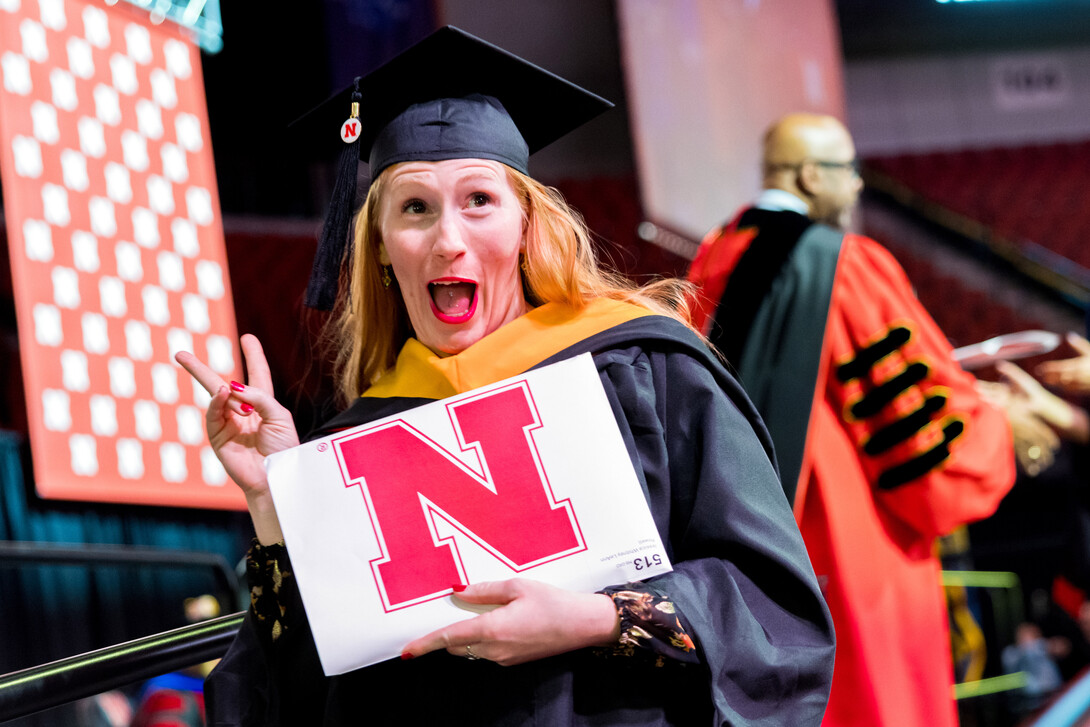Jessica Powell of Omaha celebrates after receiving her master’s degree in natural resource sciences during the graduate and professional degree ceremony Dec. 19 at Pinnacle Bank Arena.