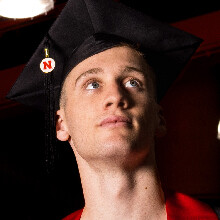 Color portrait of Tyus Wilson wearin a black graduation cap.
