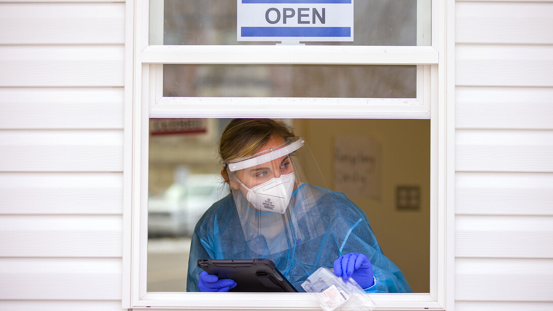 Bria Foley, a senior pre-med major and a student worker for the saliva testing, waits for the next Husker to step up on the morning of Jan. 19. 