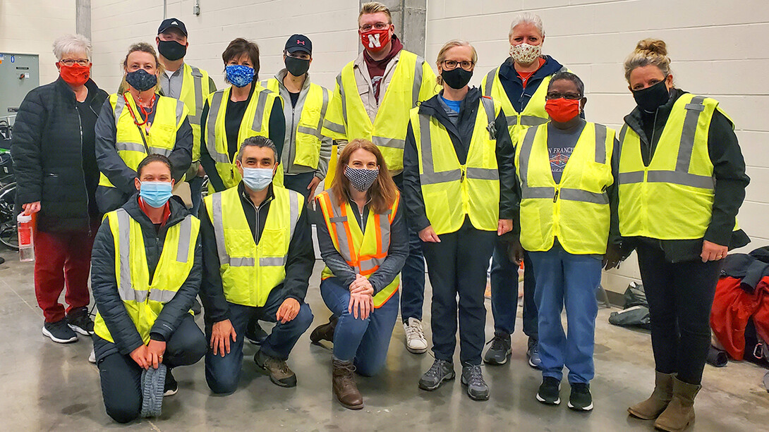 First-shift volunteers pose for a group photo following orientation on the morning of April 7. University teams filled two vaccine clinic shifts every day from April 7-9 at Pinnacle Bank Arena.