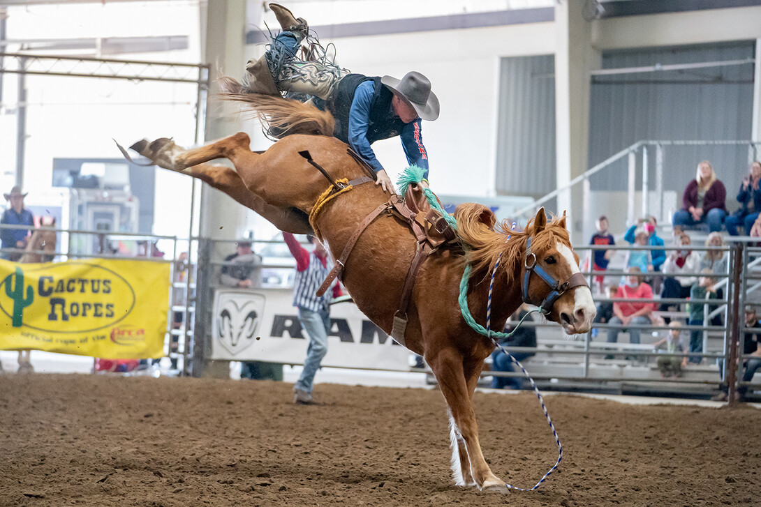 Sam Florell, a sophomore agricultural economics major, catches some air after being bucked off in the saddle bronc riding competition.