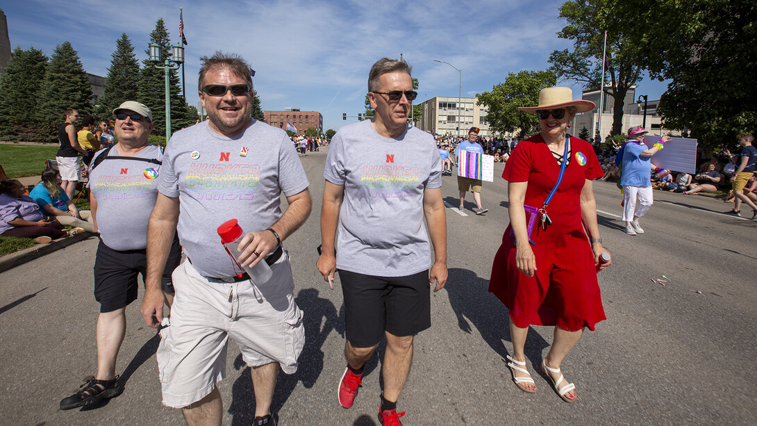 Corrie Svehla (second from left) walks the Star City Pride parade route with (from left) Bob Wilhelm, Ronnie Green, and Jane Green. More than 40 members of the campus community walked as part of the Husker Pride entry in the inaugural parade.