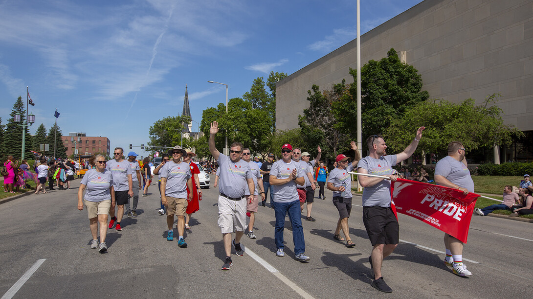 Members of the Husker Pride entry walk the parade route on June 19.