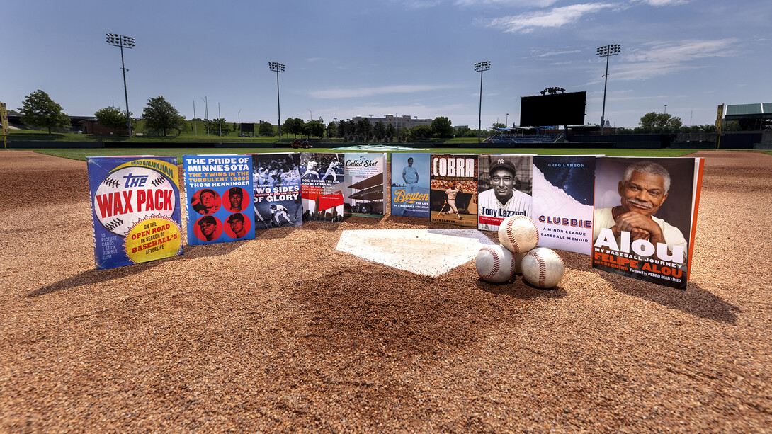 University of Nebraska Press books about baseball sitting around home plate at Haymarket Park.