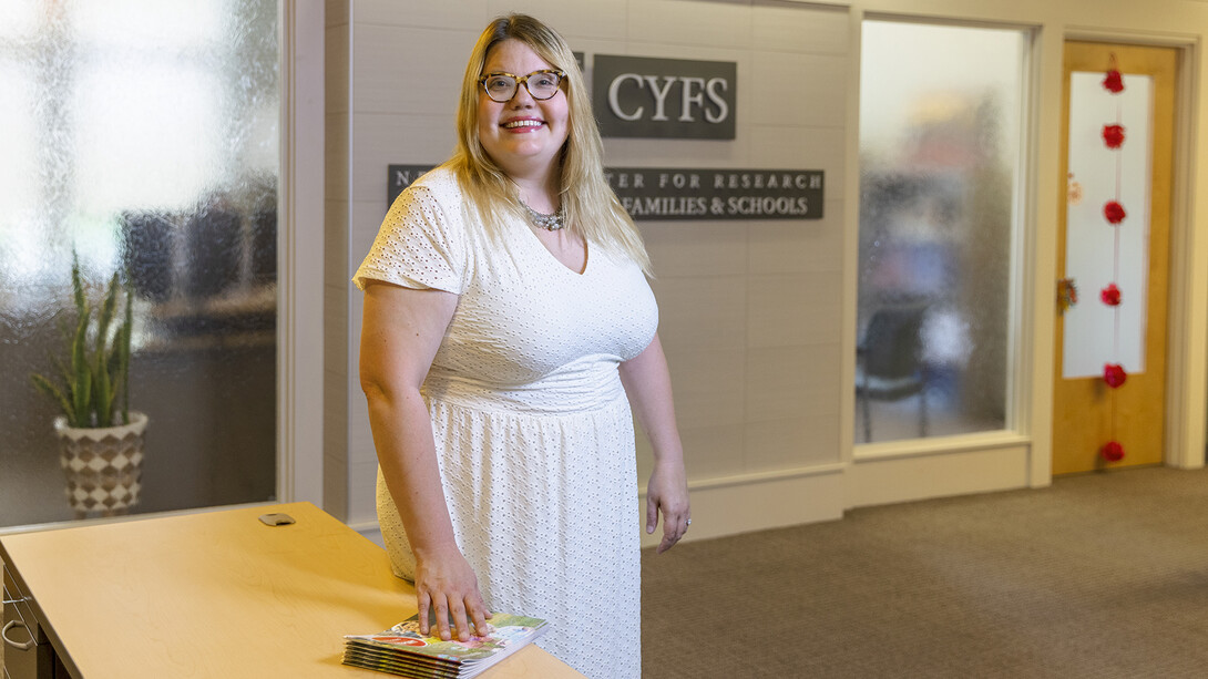 Katie Edwards standing in front of a desk.