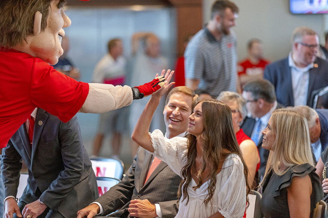 Herbie Husker gives a high five to Breanna Alberts, youngest daughter of Trev and Angie Alberts. Trev Alberts was announced as the university’s next athletic director on July 14.