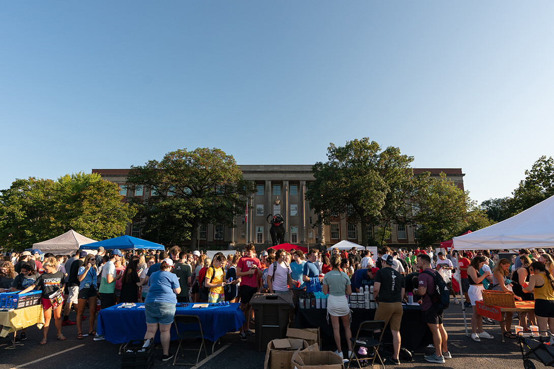 Students walk around East Memorial Stadium Loop during the Big Red Welcome Street Festival.