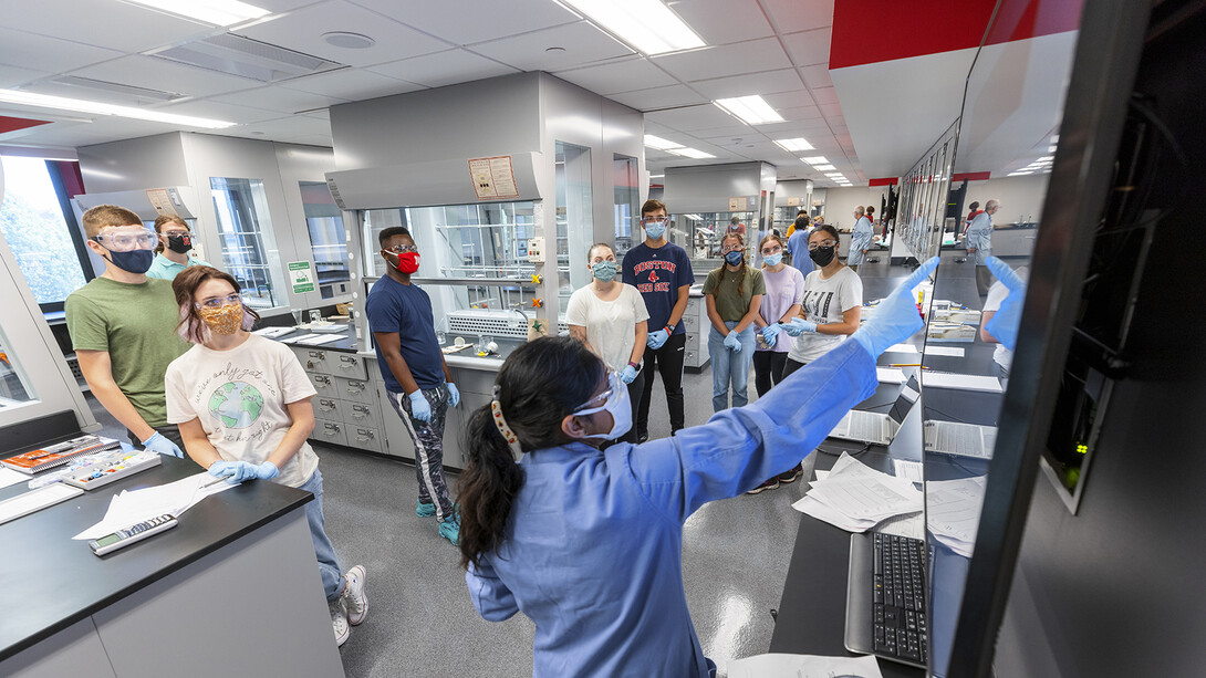 Students — all of whom are wearing masks — listen to instructions in the newly renovated organic chemistry labs in Hamilton Hall on Aug. 23, the first day of classes in the fall 2021 semester. Following an order from public health officials, the university community will start wearing masks when indoors on Aug. 25.