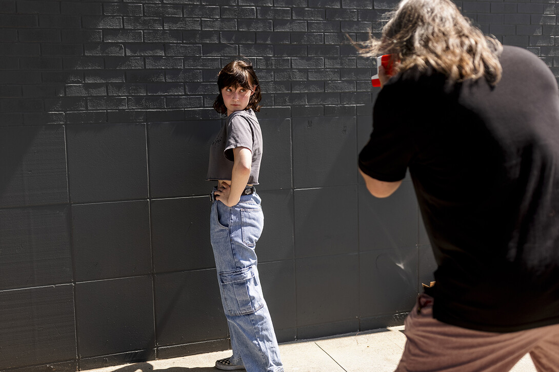 Olivia Jenkins, a sophomore from Lincoln, poses as Sean Strough, equipment and technology associate for Carson Center, takes her photo.