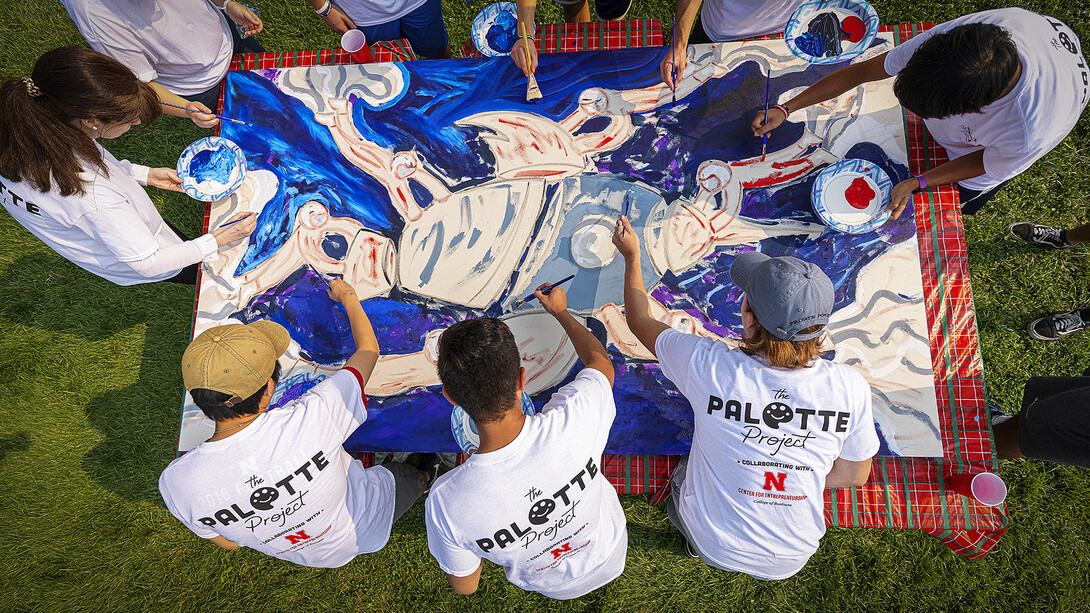 Students paint The Palette Project's first mural, a rocket, on campus on Sept.1.