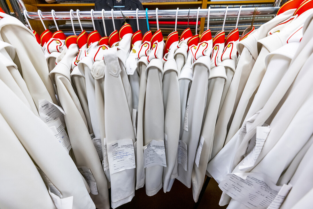 Band uniforms hang in the Delgiannises downtown tailor shop.