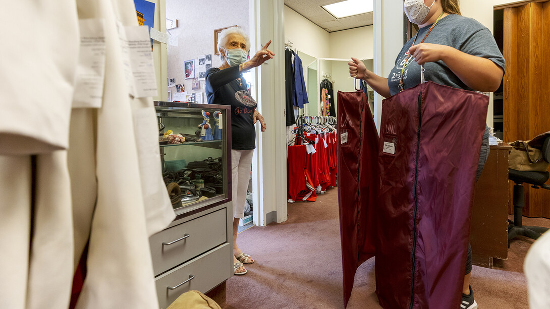 Stamatia Delgiannis directs a band members to the correct rack to pick up the finished uniforms. The couple have worked together for 51 years in a small shop within the Wells Fargo Building in downtown Lincoln.