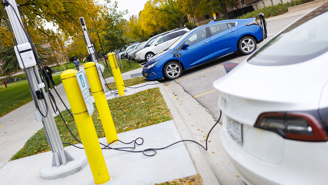 Electric cars recharge at the charging stations in front of the College of Business.