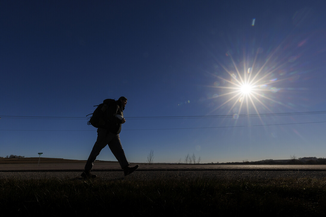 Trevor Stephens, Marine Corp veteran and a sophomore in secondary education from Council Bluffs, Iowa, walks along Highway 93 westbound from Treynor, Iowa.