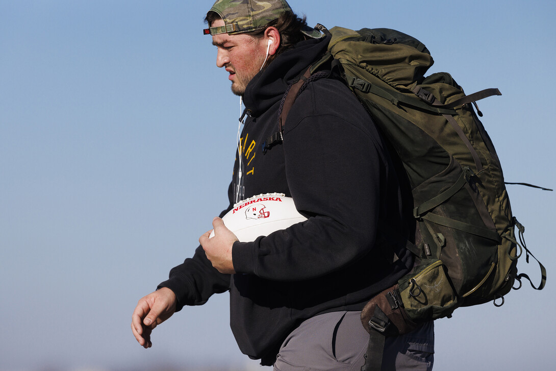 Trevor Stephens carries the game ball, and 20 pounds in his pack, recognizing the 20 veterans that die from suicide each day.