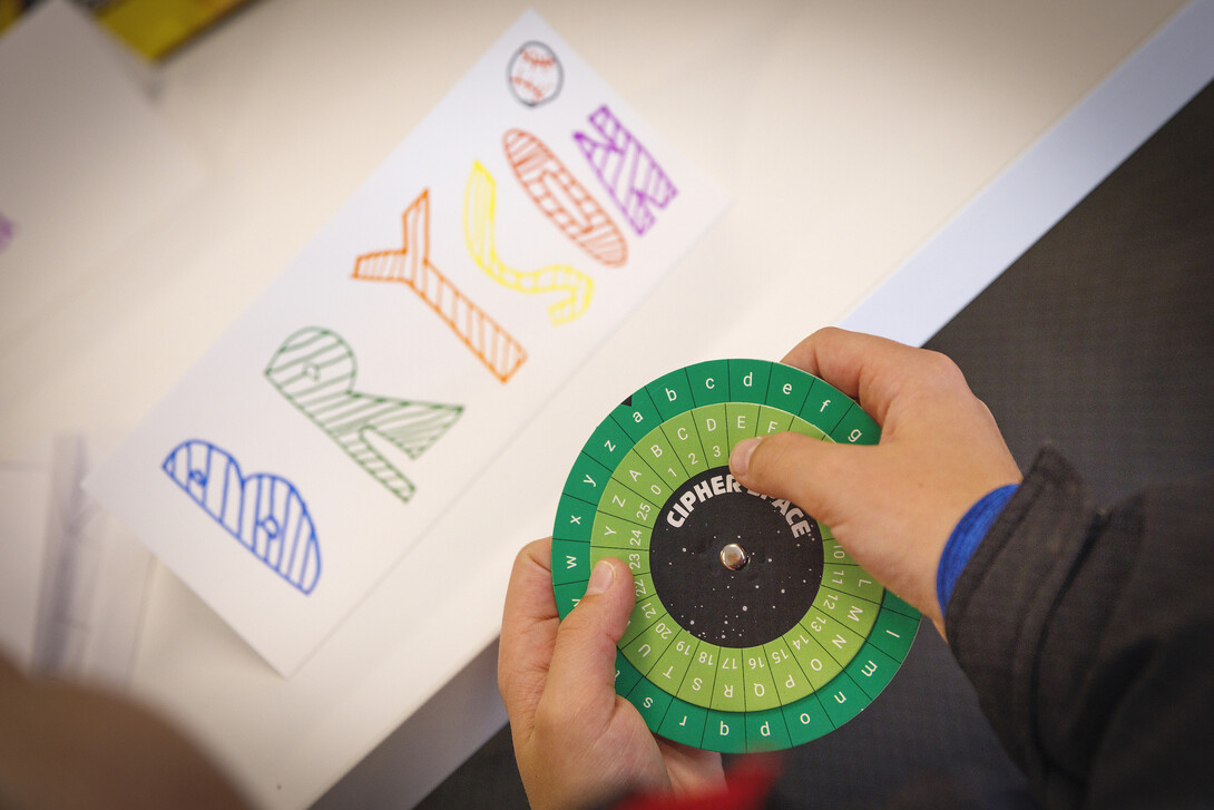 Bryson, 11, works with a cipher wheel during the "Galactic Quest" workshop at Crete Public Library