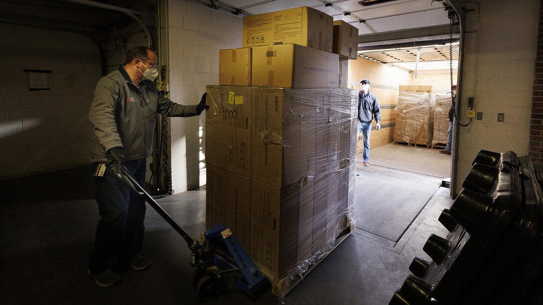 Chad Ebke, a senior material service worker with Facilities Management and Planning-Business Operations, unload cases of KN95 masks at the Nebraska Union on Feb. 1. The masks, which became available on Jan. 28, were picked up by Facilities Management and Planning employees in Omaha on Jan. 31 and distributed to campus sites for sorting on Feb. 1. 