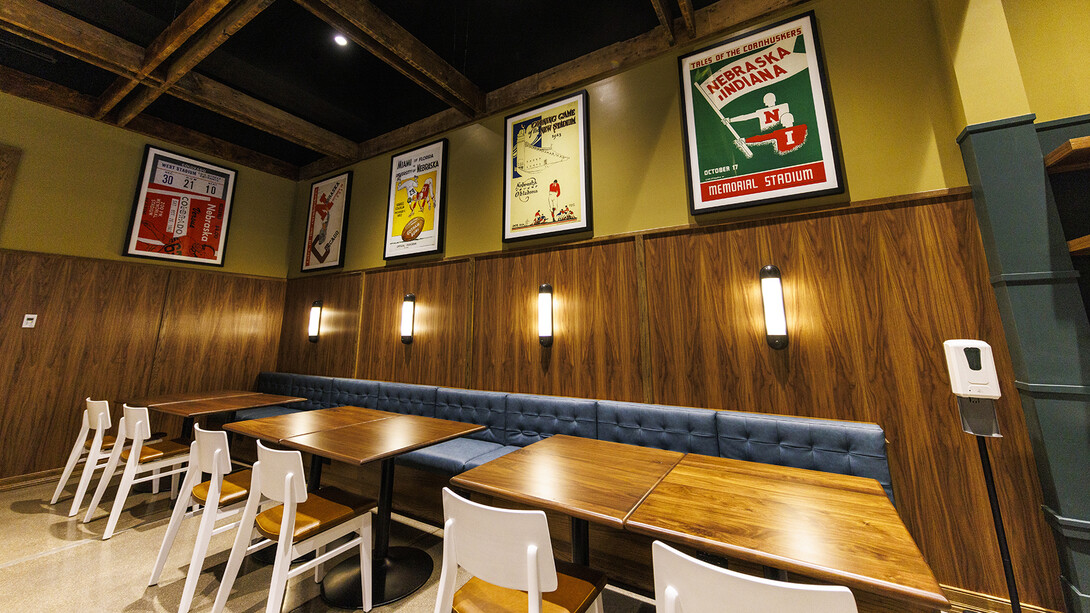 Classic Husker football posters hang in an eating space within the new Scarlet Hotel.