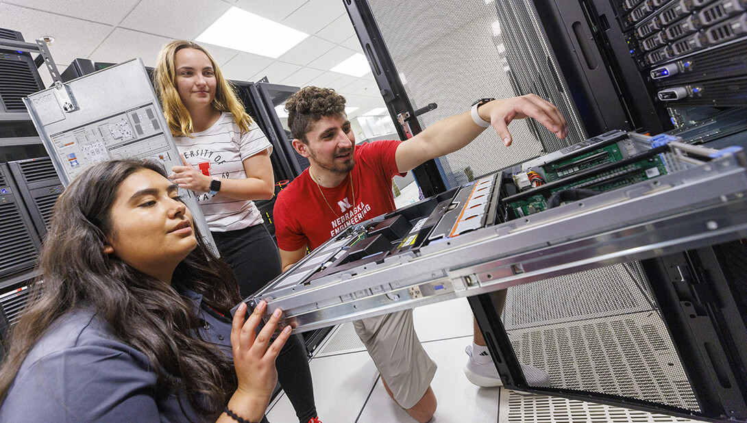 Students in the School of Computing work on a server.