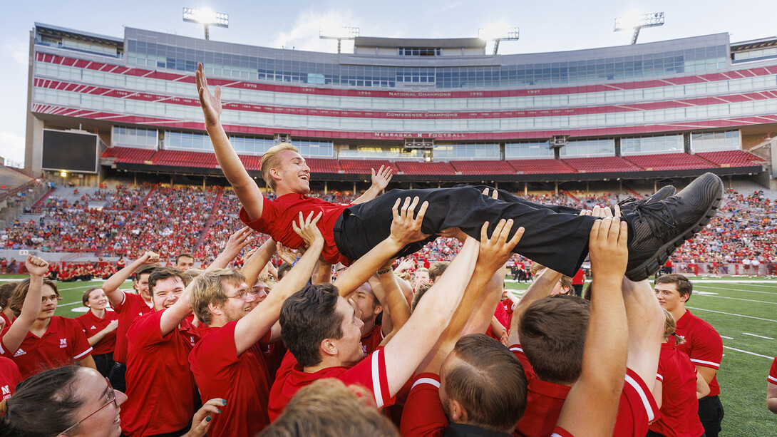 Drew Carlson, a first-year trumpet player from North Platte, is hoisted into the air after winning the Cornhusker Marching Band's annual drill down in Memorial Stadium on Aug. 19.