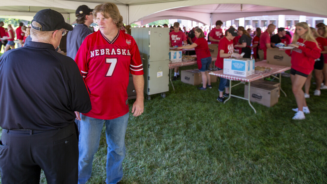 Pat McManus (in the No. 7 jersey) talks with Dave Annis, director of Dining Services, during the picnic on Aug. 19. The event served nearly 3,200 students.