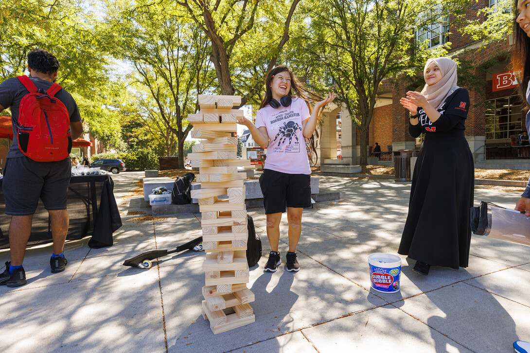 Ayela Ruiz, a freshman from Lincoln, accepts congratulations after making a difficult Jenga move from Hannah Ridzuan (right), a graduate assistant at ODI.