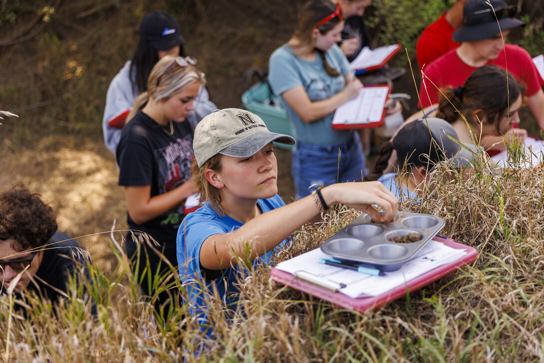 Kennadi Griffis places a sample into a tray for evaluation as she and fellow students in her NRES 279 - Soil Evaluation course work in the east campus soil pit. 