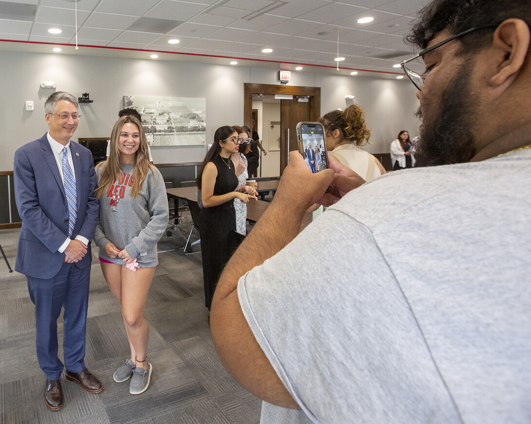 Melany Lockhart, a senior finance major from Fremont, smiles for a photo with James Kvaal in the Nebraska Union.