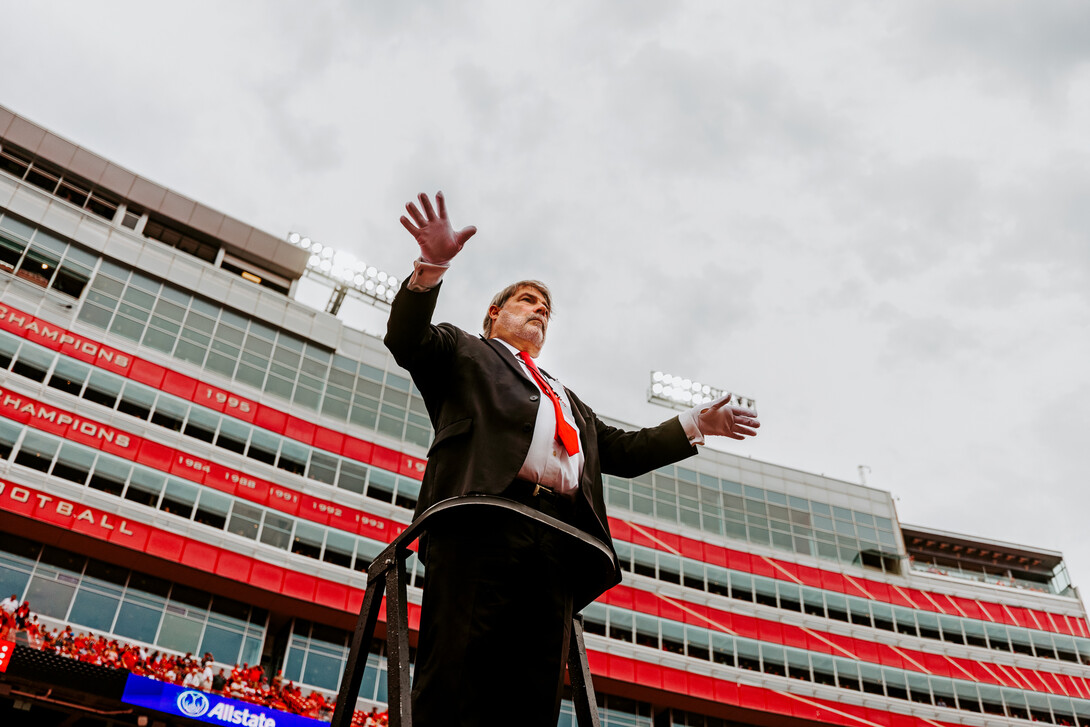 Tony Falcone—the associate director of bands—conducts the band during the NU v. OK game.