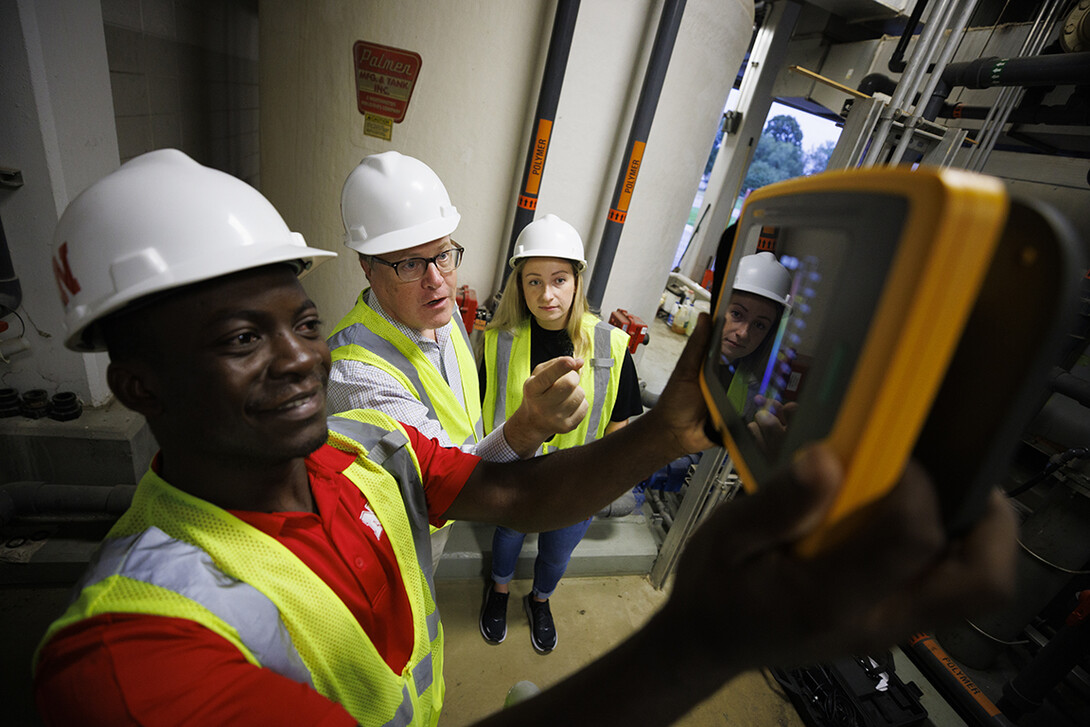 Bruce Dvorak (center), professor of civil and environmental engineering, coaches Yves Cedric Tamwo Noubissi (left), a student in mechanical engineering, and Sussan Moussavi, graduate student in civil engineering, in the use of a Fluke Precision Acoustic Imager, used to detect leaks of gases and vacuum from pipes and tanks, Sept. 23, 2022.