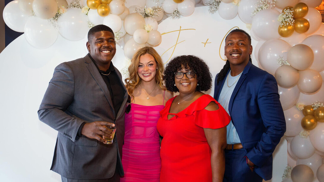 Nebraska's Charlie Foster (third from left) will receive a 20-year Employee Service Award on. Sept. 28. She is standing her with her sons (both former Husker football players) Gerald (far left) and Trey (right), and Trey's Nebraska's Charlie Foster (third from left) will receive a 20-year Employee Service Award on. Sept. 28. She is standing her with her sons (both former Husker football players) Gerald (far left) and Trey (right), and Trey's fiancè, Erin McMaster., Erin McMaster.