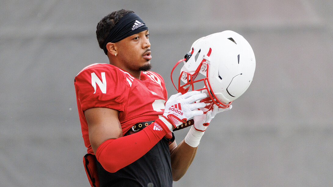 Darius Moore readies to put on his helmet during a Husker football practice in early November.