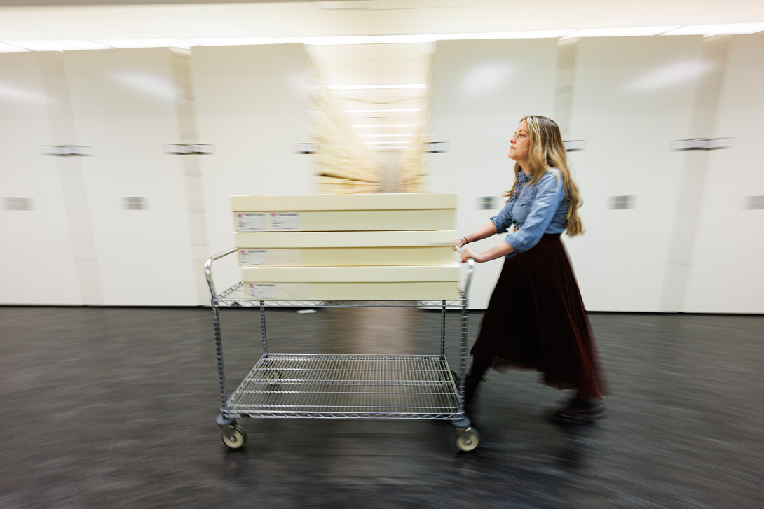 sarah walcott collections manager wheeling boxes of quilts around museum