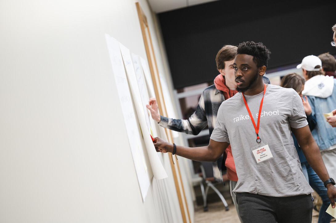 Damien Niyonshuti casts his vote for one of his favorite ideas during the opening evening of the 48-Hour Challenge