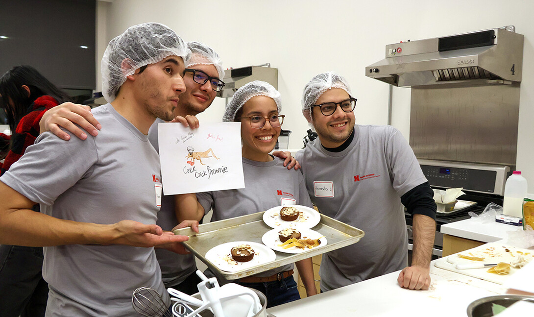 Kevin Lievano, David Fabian Gomez Quintero, Carmen Perez-Donado and Armando Lerma Fuentes take a quick photo with their plated Crick Crick Brownie before presenting to judges.