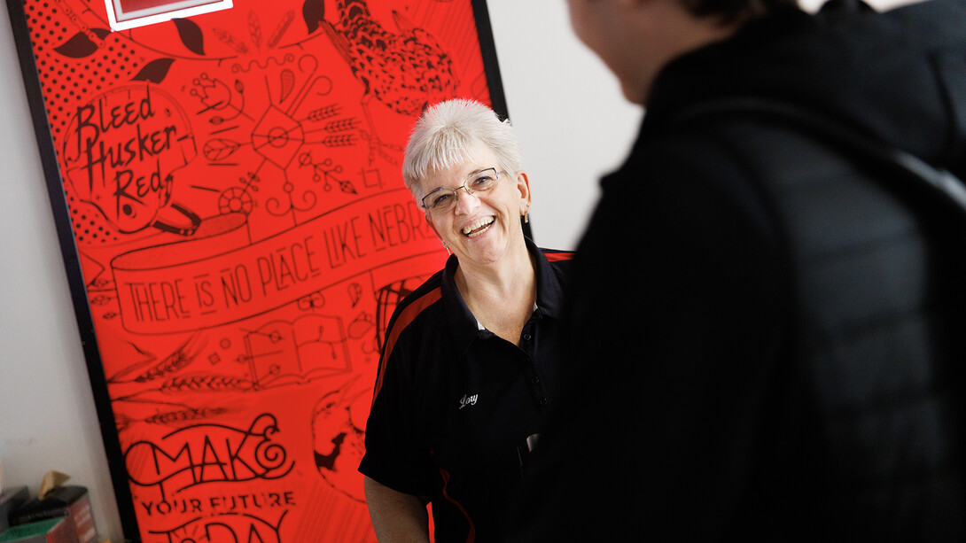 Nebraska's Lory Erving chats with a student at the Cather Dining register. Erving, a native of Hazel, South Dakota, is a checker/cashier at Cather Dining Service. Her favorite part of the job is, “Laughing and joking with the students, answering questions, providing support for coworkers, students and staff plus the challenge of balancing my sales and tickets at the end of my shift are all things I enjoy.”