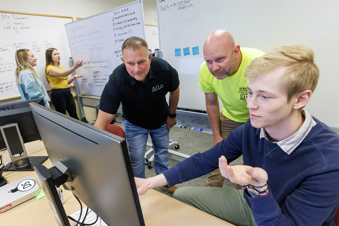 Erik Konnath (right) talks with ALLO representatives, Ed Jarrett and Jon McHenry (in yellow T-shirt) as they discuss a Raikes School Design Studio project in 2023. The design studio is the capstone of UNL’s Raikes School of Computer Science and Management, partnering students with businesses and non-profit organizations to develop real-world projects. Konnath’s team developed a system that has helped ALLO to greatly reduce response times to customer complaints. Learn more at go.unl.edu/amoh.