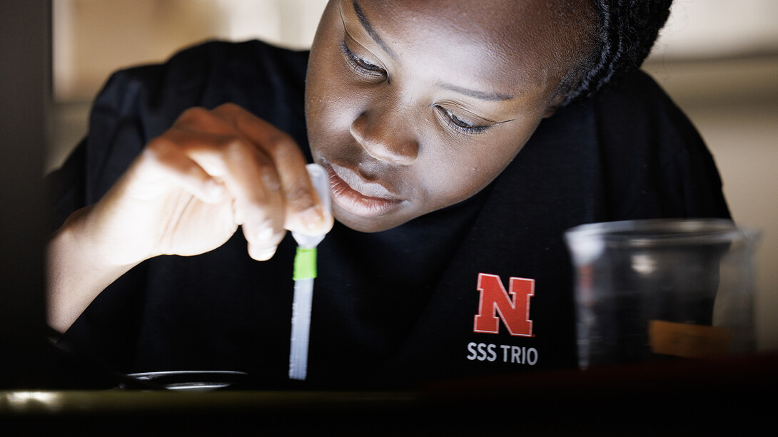 Riada Riyangow uses a pipette in Clay Clessler's biological sciences lab in Manter Hall.