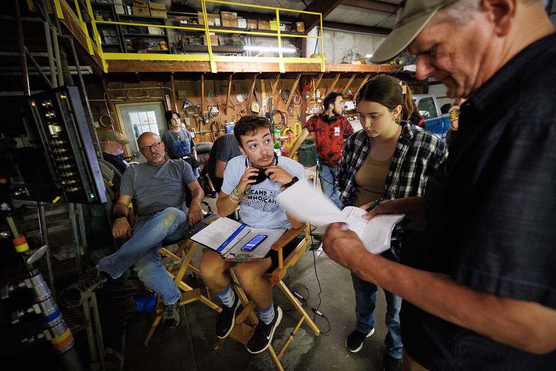 Nebraska student and script supervisor Charlie Major listens to comments by producer Jamie Vesay. At left is Richard Endacott and in the middle right is Grace Birkland, Nebraska student and second assistant cameraperson.